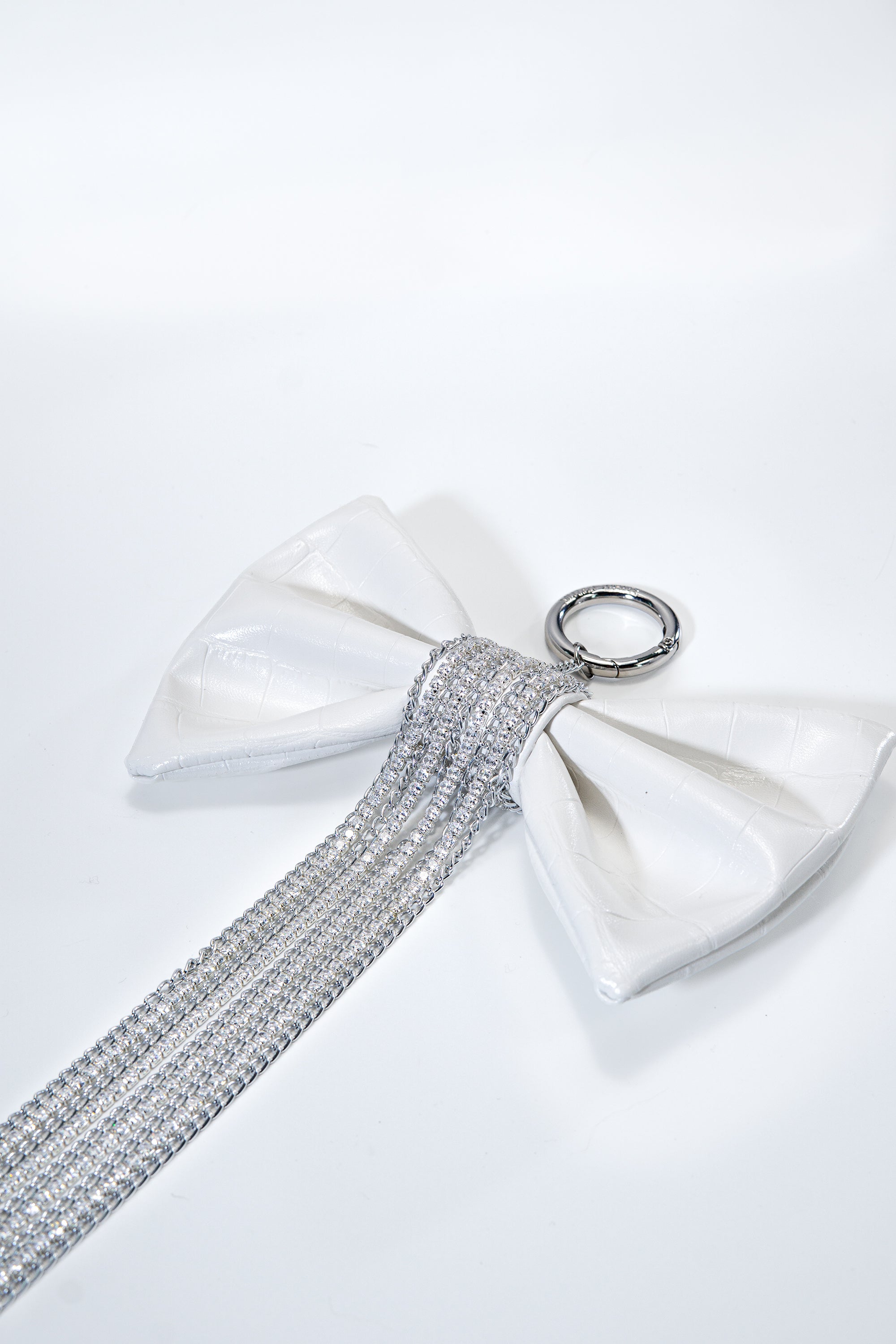 Crocodile-Embossed Bow With Cascading Fringe Chain Charm