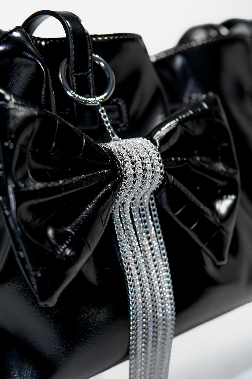 Crocodile-Embossed Bow With Cascading Fringe Chain Charm