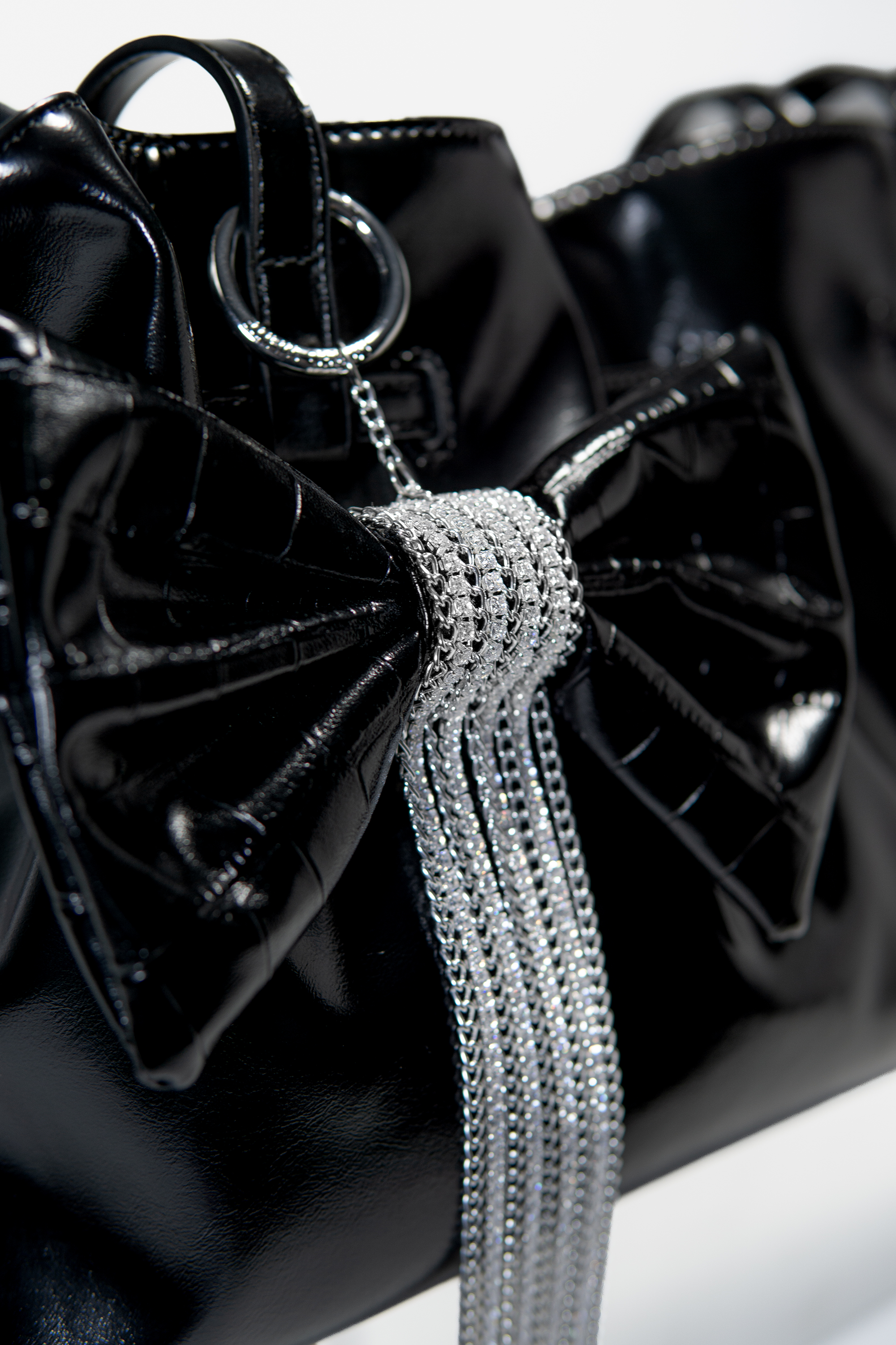Crocodile-Embossed Bow With Cascading Fringe Chain Charm