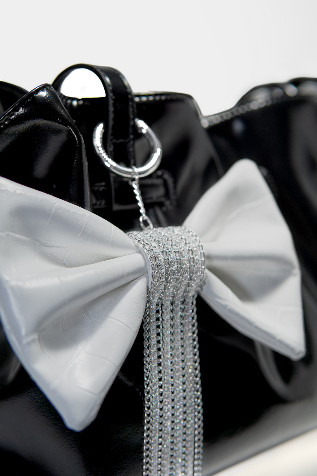 Crocodile-Embossed Bow With Cascading Fringe Chain Charm