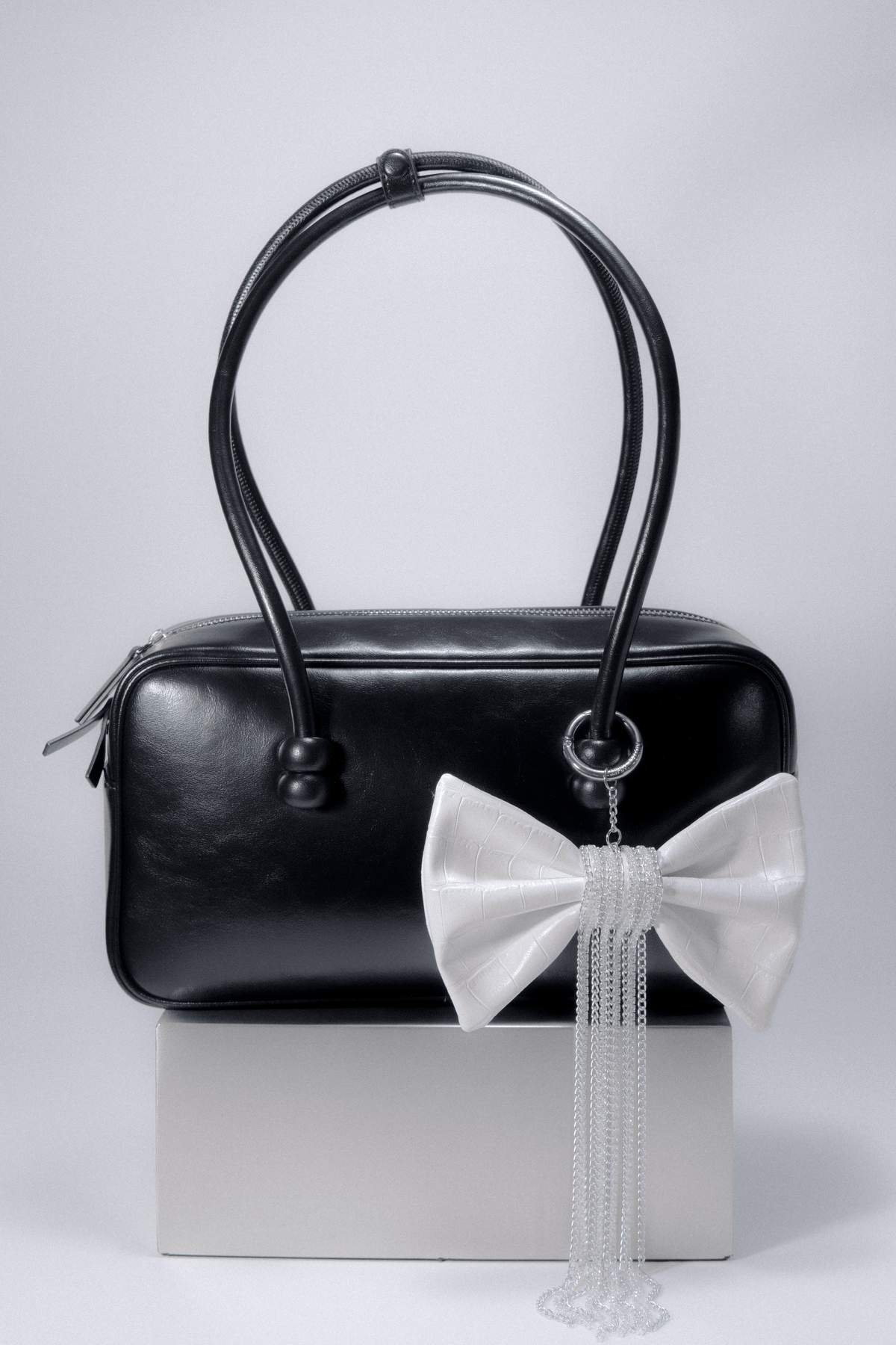 Crocodile-Embossed Bow With Cascading Fringe Chain Charm