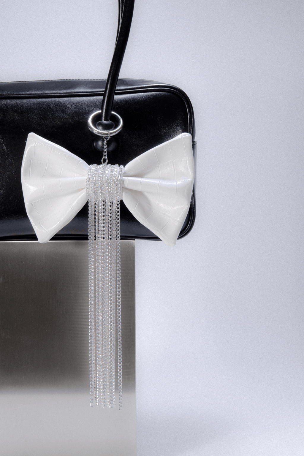 Crocodile-Embossed Bow With Cascading Fringe Chain Charm