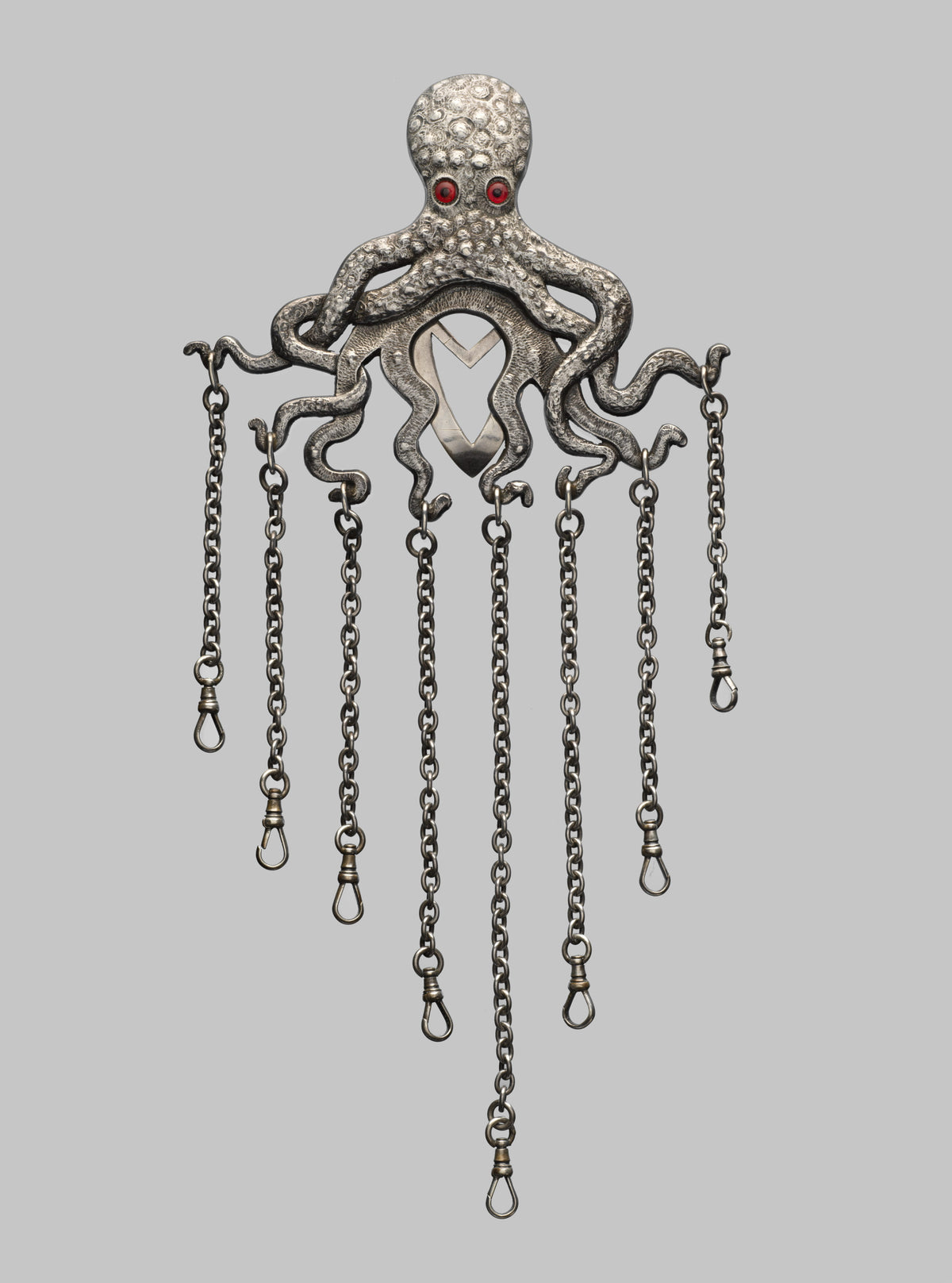 Silver octopus chatelaine by Gorham, 1887, with red glass eyes and hanging chains
