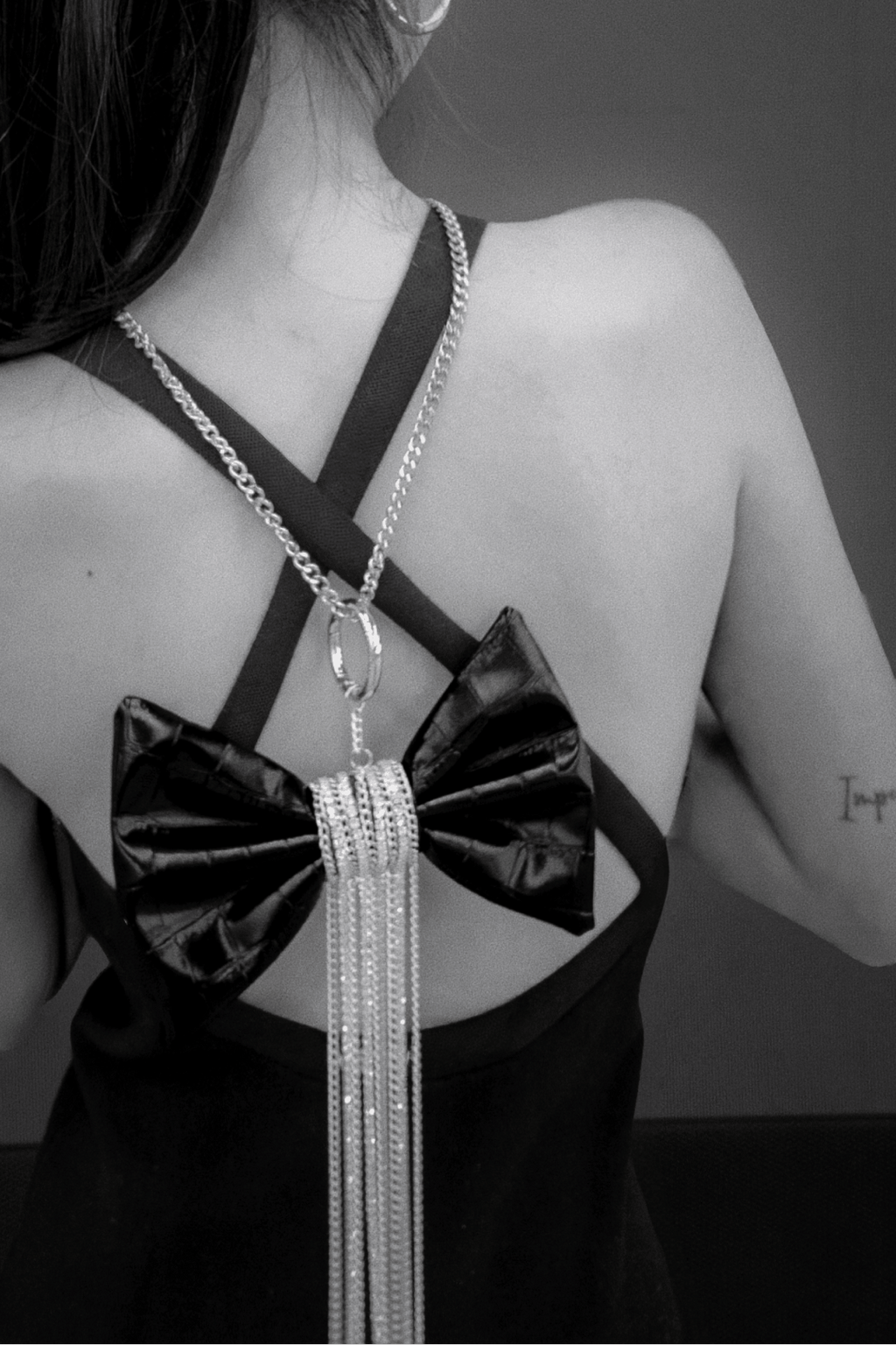 Crocodile-Embossed Bow With Cascading Fringe Chain Charm